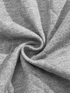 Macro shot of grey heathered jacquard fabric texture on long sleeve Henley shirt