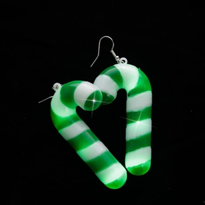 Detail of candy cane Christmas earrings in heart shape with festive LED glowing effect