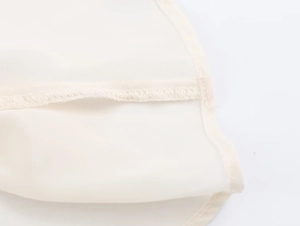 Macro view showing the high-quality stitching and seaming on beige georgette fabric