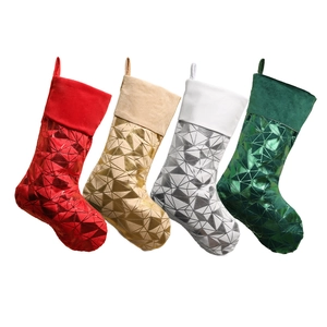 Set of four shiny metallic Christmas stockings in red, gold, silver and green with velvet cuffs