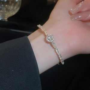 Detailed close-up of a silver zircon bracelet featuring round and baguette-cut stones