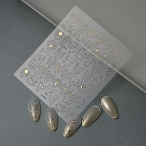 Macro detail of gold embossed 5D nail stickers featuring minimalist geometric line patterns