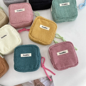 Flat lay of colorful corduroy cosmetic bags with zipper closure and wrist strap