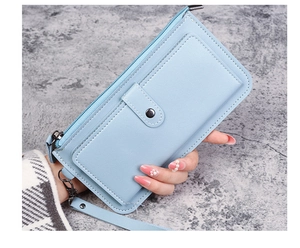 Detail of light blue faux leather long wallet with litchi texture and wristlet strap