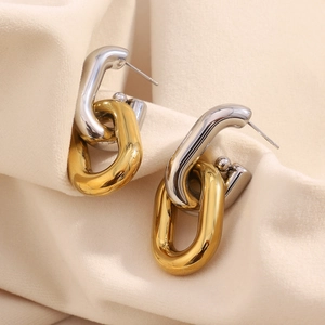 Detailed view of interconnected chain-link stud earrings in polished gold and silver steel