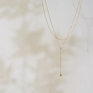 Minimalist Y-shaped 18K gold-plated stainless steel layered necklace with a gold ball pendant