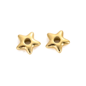 Close-up of two golden star-shaped metal spacer beads with central holes for DIY jewelry