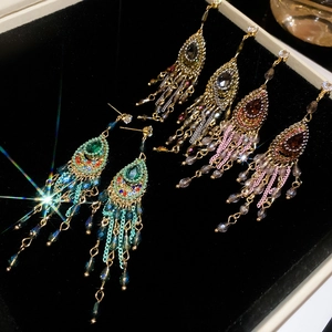 Detailed close-up of Bohemian drop earrings with colorful crystals and long tassels
