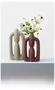 Modern Nordic ceramic vases in beige and brick red with an abstract U-shaped geometric design
