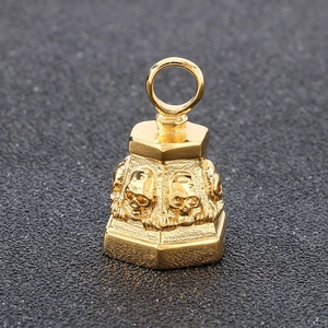 Macro shot of gold punk skull bell pendant featuring detailed gothic relief and top ring