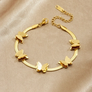 Gold stainless steel snake chain bracelet with frosted butterfly charms on silk background
