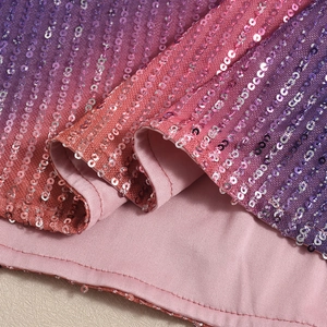 Detailed close-up of purple and pink gradient sequin fabric with soft inner lining