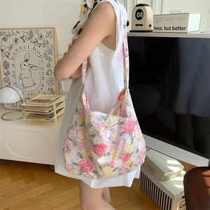 Close-up of stylish floral canvas tote bag showing pink and yellow pattern details