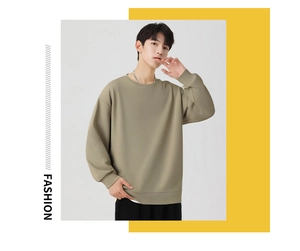 Close-up of khaki crewneck sweatshirt showing thick knitted fabric and drop shoulder detail