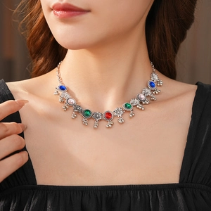 Close-up of vintage floral necklace with multicolor gemstones on a model's neck