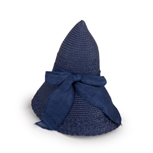 Close-up of navy blue straw sun hat showing fine woven texture and decorative bow