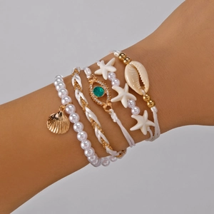 Bohemian multilayer pearl bracelet set with starfish and seashell charms on wrist