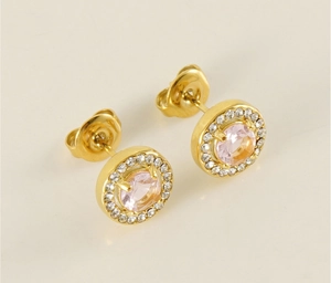 Close-up of gold titanium steel earrings with pink zircon stone and halo crystal detail