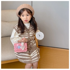 Detail of girls' vintage style striped knit vest and skirt set with pearl handbag