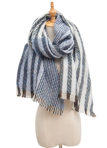 Detail of striped knit scarf with colorful specks and fringe on a white studio background