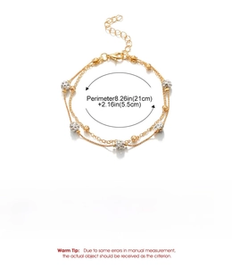 Detail showing gold double-layer anklet with crystal disco balls and size parameters