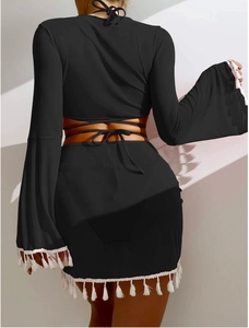 Detail eines schwarzen Boho-Strandsets mit rückenfreiem Top und weißen Fransenrock