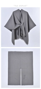Flat and hanging tile display of a grey poncho with tassel fringes and tie-up neck detail