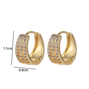 Detail view of gold huggie earrings with triple row zircon inlay showing 1.5cm height