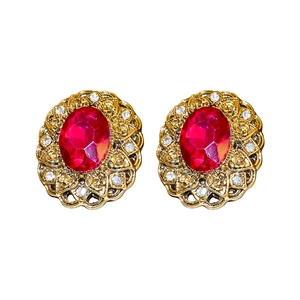 Vintage oval ruby crystal earrings with gold filigree and rhinestone accents on white back
