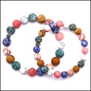 Flat lay of colorful beaded bracelets with natural stones including lapis lazuli and jasper
