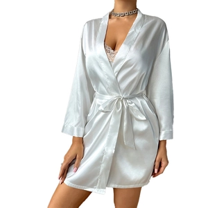 Elegant white satin robe with silky texture, long sleeves and lace trim on a white background