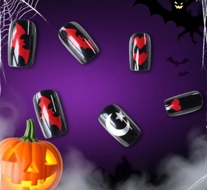 Halloween press-on nails detail with red bats, hearts, and stars on black glossy base