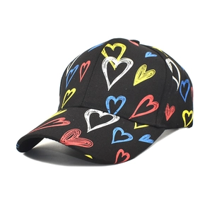 Black cotton baseball cap with colorful heart graffiti pattern in a side 45-degree view