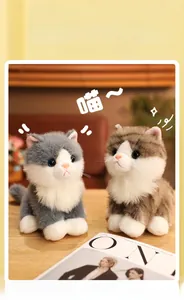 Close-up of lifelike plush cats in grey and brown with realistic glass eyes on wooden desk