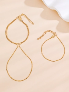 Detail of adjustable gold-plated layered chain bracelet with pearls and lobster clasp
