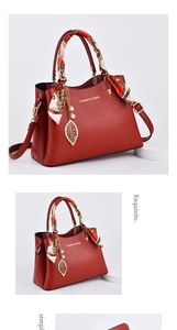 Detail of red bridal handbag with lychee pattern PU leather and silk scarf handle