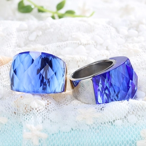 Macro detail of sky blue and cobalt blue faceted crystal rings with silver metal band