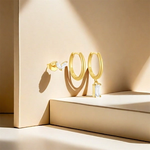 Detailed view of S925 sterling silver gold earrings set with zircon stones and leaf studs