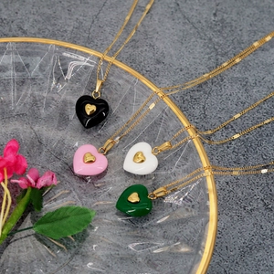 Elegant gold chain necklaces featuring heart pendants in black pink white and green colors