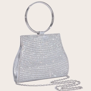 Macro shot of silver diamond evening clutch bag with sparkling rhinestones and metal ring handle