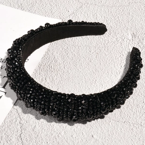 Close-up of a Baroque padded headband featuring intricate black crystal beadwork details