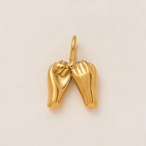 Détail macro d'un pendentif promesse en plaqué or 18K avec une finition polie et brillante