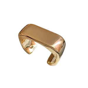 Minimalist chunky wave cuff bracelet in polished gold finish with a modern open design
