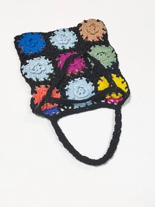 Detailed close-up of colorful crochet flower granny square patterns on a knit shoulder bag