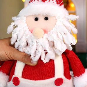 Close-up of Santa Claus plush toy showing red knitted hat and soft white faux fur details
