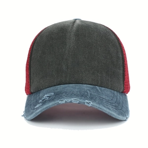 Detail of distressed brim and breathable red mesh on a vintage washed trucker hat