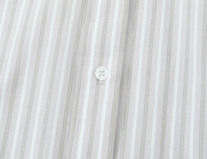 Detailed macro view of gray and white striped poplin fabric with white button fastening