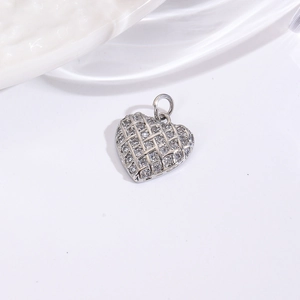 Macro shot of silver heart pendant with woven texture and micro-pave clear gemstones