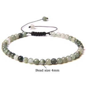 Detail view of 4mm natural stone beads on a black adjustable braided yoga bracelet