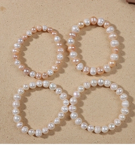 Detailed view of natural freshwater pearl bracelets in white and pink-orange tones